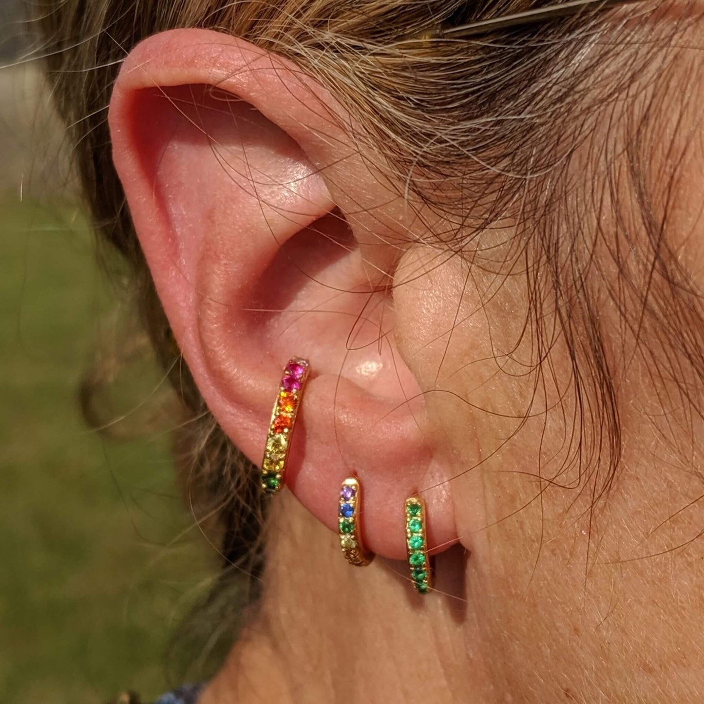 rainbow cuff and rainbow huggies in ear