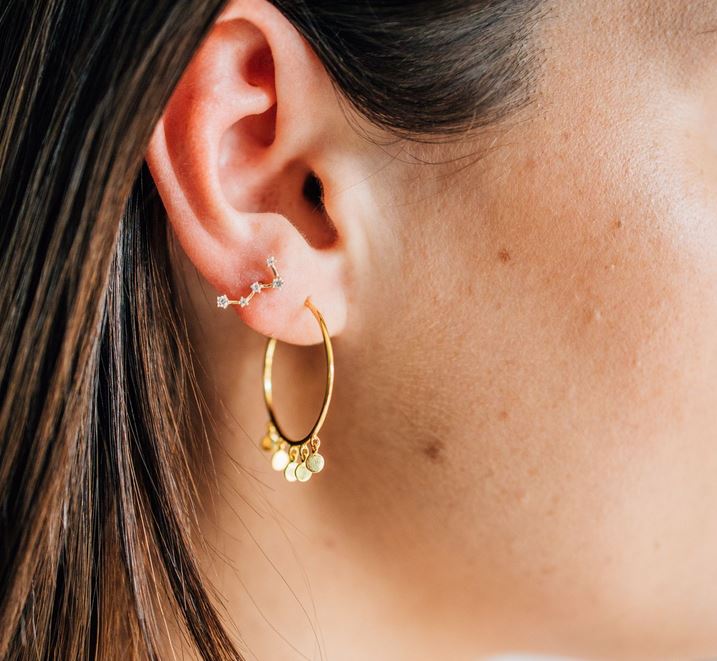 constellation barbel in second hole ear with big hoop in first with gold drop discs